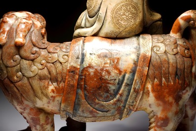 A Chinese soapstone figure of the immortal Vajraputra on a Buddhist lion, Kangxi/Qianlong