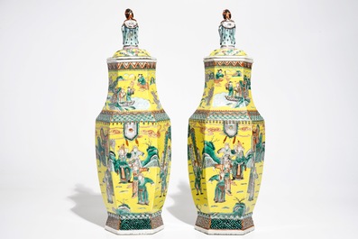 A pair of Chinese hexagonal famille verte yellow-ground vases and covers, 19th C.