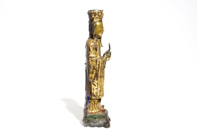 Een Chinese deels vergulde en polychrome bronzen figuur van Wenchang Dijun, Ming