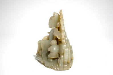 A Chinese pale celadon jade group of Guanyin with a boy, 19/20th C.
