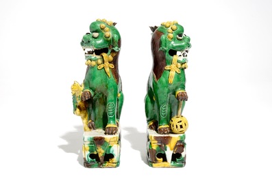 A pair of Chinese verte biscuit joss stick holders shaped as Buddhist lions, Kangxi