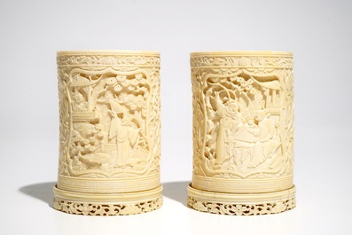 A pair of Chinese ivory brushpots with figural design, 19th C.