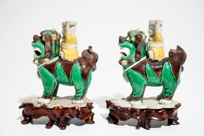 A pair of Chinese verte biscuit joss stick holders shaped as warriors on Buddhist lions, Kangxi