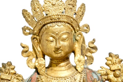A large Chinese gilt bronze and cloisonn&eacute; figure of Green Tara, 19th C.