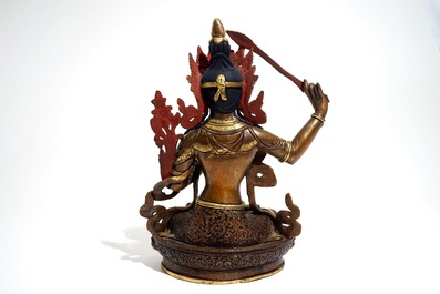 A Sino-Tibetan gilt bronze figure of Manjusri with coral and turquoise insets, 19/20th C.