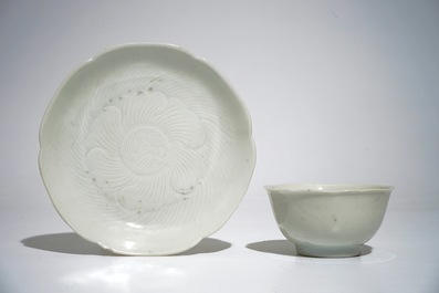 Three blanc de Chine cups and saucers with floral anhua design, Yongzheng/Qianlong