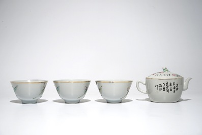 A Chinese qianjiang cai teapot and three famille rose cups, 19th C