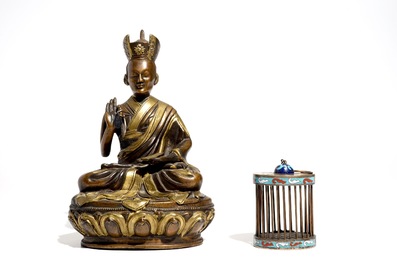 A Chinese bronze model of a seated Buddha and a cloisonn&eacute; cricket case, 19/20th C.