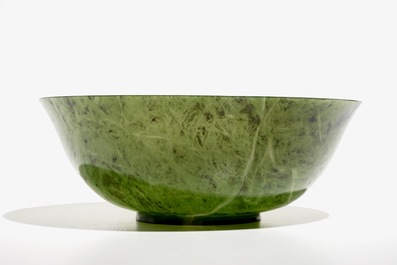 A Chinese thin-walled spinach green jade bowl, 20th C.