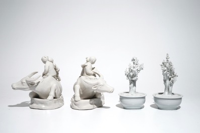 A pair of Chinese Dehua blanc de Chine prunus trees, Kangxi, and a pair of water buffalos with children, 20th C.