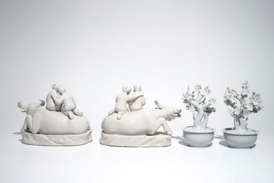 A pair of Chinese Dehua blanc de Chine prunus trees, Kangxi, and a pair of water buffalos with children, 20th C.
