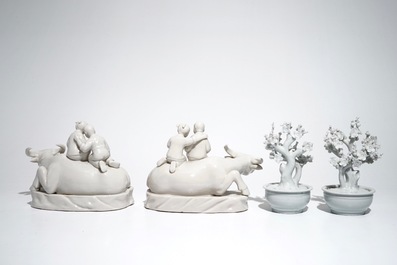 A pair of Chinese Dehua blanc de Chine prunus trees, Kangxi, and a pair of water buffalos with children, 20th C.