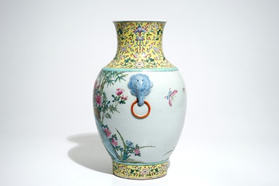 A Chinese famille rose hu vase with birds among flowers on rockwork, Qianlong mark, 19/20th C.