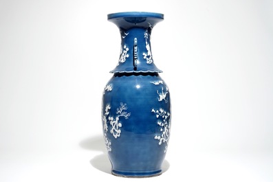 A tall Chinese blue-ground vase with applied white design, 19th C.