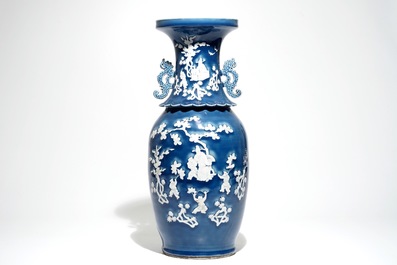 A tall Chinese blue-ground vase with applied white design, 19th C.