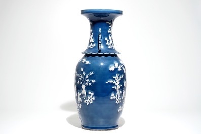 A tall Chinese blue-ground vase with applied white design, 19th C.