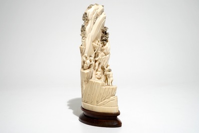 A Chinese ivory group of miners on a rock, 2nd quarter 20th C.