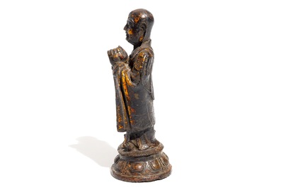 A Chinese gilt-laquered bronze figure of a monk, Ming