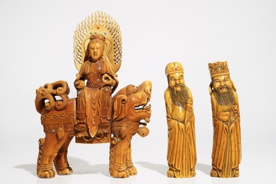 A Chinese ivory model of Guanyin on a Buddhist lion and two sages, 19th C.