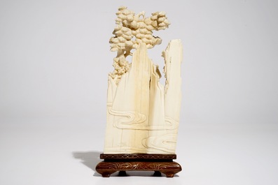 A Chinese ivory group on wooden stand, 2nd quarter 20th C.