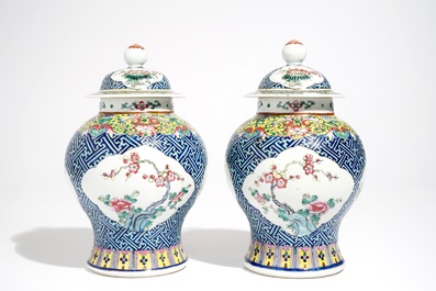 A pair of Chinese famille rose vases and covers, 19th C., and a pair of blue and white dishes, 20th C.