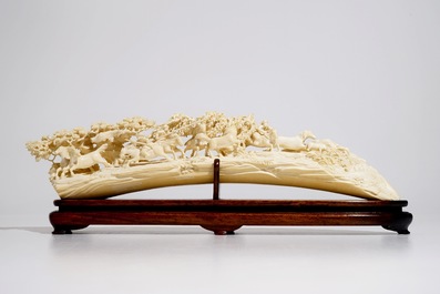 A Chinese ivory carving with hunting scene on wooden stand, ca. 1900