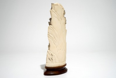 A Chinese ivory group of miners on a rock, 2nd quarter 20th C.