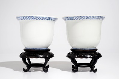 A pair of small Chinese famille rose jardinieres on wooden stands, early 20th C.