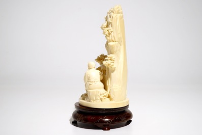 A Chinese ivory group with figures and sheep on wooden stand, 2nd quarter 20th C.