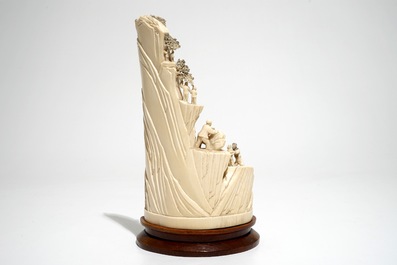 A Chinese ivory group of miners on a rock, 2nd quarter 20th C.