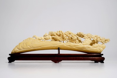 A Chinese ivory carving with hunting scene on wooden stand, ca. 1900