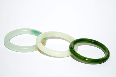 Three Chinese celadon and spinach green jade bangles, 19/20th C.