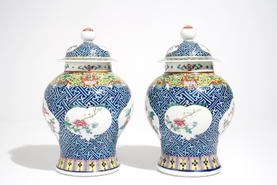 A pair of Chinese famille rose vases and covers, 19th C., and a pair of blue and white dishes, 20th C.