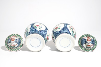 A pair of Chinese famille rose vases and covers, 19th C., and a pair of blue and white dishes, 20th C.