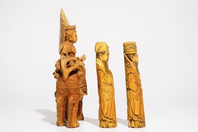A Chinese ivory model of Guanyin on a Buddhist lion and two sages, 19th C.