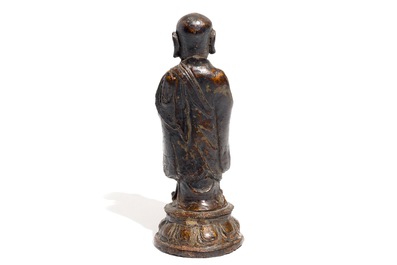 A Chinese gilt-laquered bronze figure of a monk, Ming