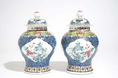 A pair of Chinese famille rose vases and covers, 19th C., and a pair of blue and white dishes, 20th C.