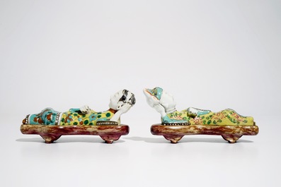 A pair of Chinese famille rose wall pocket vases shaped as resting figures, early 19th C.