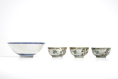 Three Chinese famille verte crackle glaze cups and saucers and a blue and white soft paste bowl, Kangxi