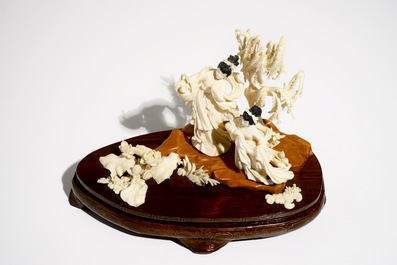 A Chinese carved ivory group of two ladies on wooden base, 2nd quarter 20th C.