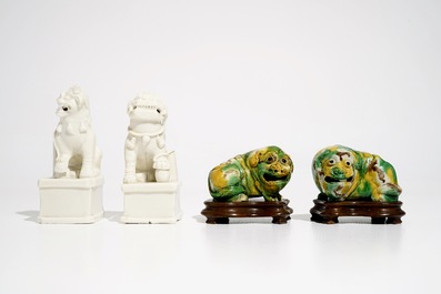 A pair of Chinese Dehua blanc de Chine Buddhist lion joss stick holders and a pair of verte biscuit dogs, Kangxi