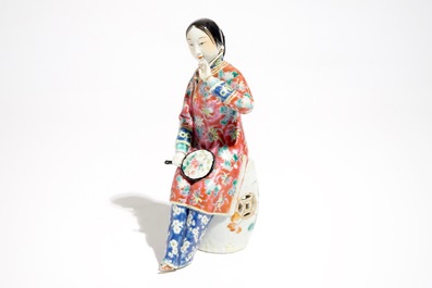 A Chinese famille rose model of a lady on a garden seat, 19th C.