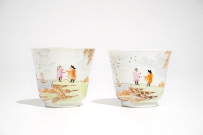 A pair of Chinese Meissen style cups and saucers with a harbour scene, Qianlong