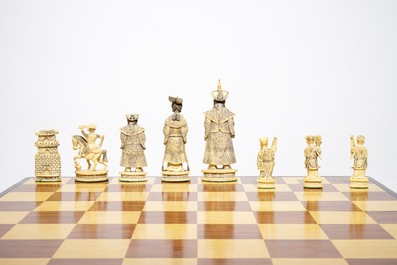 A large Chinese carved ivory chess set with board, 2nd quarter 20th C.