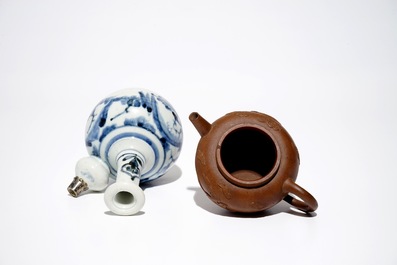 A Chinese Yixing stoneware teapot, two blue and white plates and a silver-mounted kendi, Kangxi/Qianlong