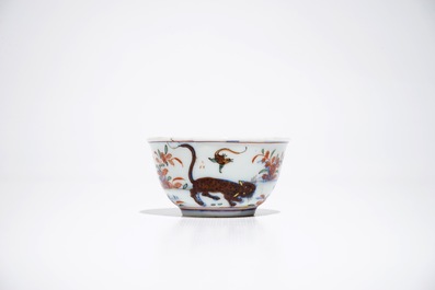 A Chinese Dutch-decorated Amsterdams bont cup and saucer with a tiger, Kangxi/Qianlong