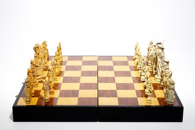 A large Chinese carved ivory chess set with board, 2nd quarter 20th C.