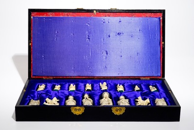 A large Chinese carved ivory chess set with board, 2nd quarter 20th C.