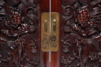 A Chinese two doors cabinet in hongmu and huanghuali with zitan dragon panels, 18/19th C.