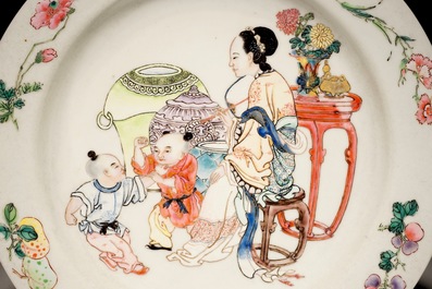 A Chinese famille rose ruby back eggshell plate with a lady and playing boys, Yongzheng